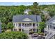Exterior view of a yellow two-story condo building with stairs to covered front porches at 5038 Belleglen Ct. # 202, Myrtle Beach, SC 29579