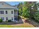 Back exterior view showcasing a yellow two-story home with screened-in porch and backyard at 5038 Belleglen Ct. # 202, Myrtle Beach, SC 29579