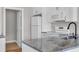 Bright kitchen featuring granite countertops, white cabinets, and stainless steel sink at 5038 Belleglen Ct. # 202, Myrtle Beach, SC 29579