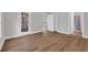 Bright living room with wood flooring, white trim, and door to a screened porch at 5038 Belleglen Ct. # 202, Myrtle Beach, SC 29579