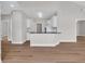 Open-concept living area with wood floors, white trim, and a kitchen view at 5038 Belleglen Ct. # 202, Myrtle Beach, SC 29579