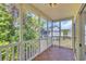 Screened porch with wood floors and view of backyard at 5038 Belleglen Ct. # 202, Myrtle Beach, SC 29579