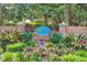 Community sign with flowering landscape and manicured greenery at 5038 Belleglen Ct. # 202, Myrtle Beach, SC 29579