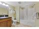 Neutral toned bathroom featuring a tub-shower, vanity with dark countertop and tiled floor at 504 N Ocean Blvd. N # 309, Myrtle Beach, SC 29577