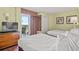 Bright bedroom featuring 2 beds, dresser with TV, balcony access and neutral walls at 504 N Ocean Blvd. N # 309, Myrtle Beach, SC 29577