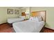 Bright bedroom featuring 2 beds, bedside table, and warm neutral walls and patterns at 504 N Ocean Blvd. N # 309, Myrtle Beach, SC 29577