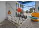 Indoor recreation area with chess with black and white pieces and an orange beach umbrella at 504 N Ocean Blvd. N # 309, Myrtle Beach, SC 29577