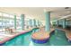 Bright indoor lazy river with tables and chairs for relaxing by the water at 504 N Ocean Blvd. N # 309, Myrtle Beach, SC 29577