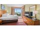 Inviting main bedroom with beach views, wooden furnishings, and plush bedding at 504 N Ocean Blvd. N # 309, Myrtle Beach, SC 29577