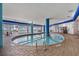 Bright indoor pool area with lounge seating, brick flooring, and views of the outdoors at 504 N Ocean Blvd. N # 309, Myrtle Beach, SC 29577