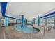 Indoor pool with surrounding lounge area, blue pillars, tile flooring, and large windows at 504 N Ocean Blvd. N # 309, Myrtle Beach, SC 29577