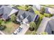 Aerial view showcasing the home's roof, a driveway with parked cars, and verdant landscaping at 523 Stonemason Dr., Myrtle Beach, SC 29579