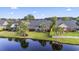 Aerial view of a home on a pond with lush landscaping and a white picket fence at 523 Stonemason Dr., Myrtle Beach, SC 29579