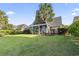 Expansive backyard with manicured lawn, mature landscaping, and a screened-in porch at 523 Stonemason Dr., Myrtle Beach, SC 29579