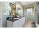 Dual vanity bathroom with framed mirrors, decorative lamps, and white cabinetry at 523 Stonemason Dr., Myrtle Beach, SC 29579