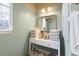 Well-lit bathroom with a vanity area, a stool, and storage organizers on the counter at 523 Stonemason Dr., Myrtle Beach, SC 29579