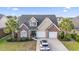 Charming two-story home with brick accents, two-car garage, well-manicured lawn, and mature palm trees at 523 Stonemason Dr., Myrtle Beach, SC 29579