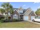 Charming two-story home featuring brick accents, a two-car garage, and mature landscaping at 523 Stonemason Dr., Myrtle Beach, SC 29579