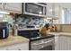 Modern kitchen featuring stainless steel appliances, tile backsplash, and ample counter space at 523 Stonemason Dr., Myrtle Beach, SC 29579