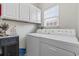 Functional laundry room with white cabinets and modern washer and dryer appliances at 523 Stonemason Dr., Myrtle Beach, SC 29579