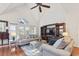 Bright living room featuring hardwood floors, vaulted ceilings, large windows, and comfortable seating at 523 Stonemason Dr., Myrtle Beach, SC 29579