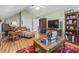 Comfortable living room featuring hardwood floors, a ceiling fan, and cozy seating arrangements at 523 Stonemason Dr., Myrtle Beach, SC 29579