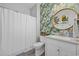 Stylish bathroom with attractive wall paper, attractive mirror and vanity sink, and white shower curtain at 5750 Oyster Catcher Dr. # 333, North Myrtle Beach, SC 29582
