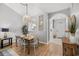 Bright dining area features an elegant table, decorative pendant light, and beautiful hardwood floors at 5750 Oyster Catcher Dr. # 333, North Myrtle Beach, SC 29582