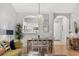 Bright dining area features an elegant table, decorative pendant light, and beautiful hardwood floors at 5750 Oyster Catcher Dr. # 333, North Myrtle Beach, SC 29582