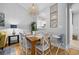 Bright dining area features an elegant table, decorative pendant light, and beautiful hardwood floors at 5750 Oyster Catcher Dr. # 333, North Myrtle Beach, SC 29582
