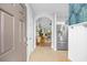 Inviting hallway with tile floors leads to an open living space, complemented by a modern stainless-steel refrigerator at 5750 Oyster Catcher Dr. # 333, North Myrtle Beach, SC 29582