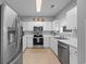 Bright kitchen features white cabinets, stainless steel appliances, and a neutral backsplash, creating a clean, modern space at 5750 Oyster Catcher Dr. # 333, North Myrtle Beach, SC 29582