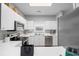 Bright kitchen features white cabinets, stainless steel appliances, and a neutral backsplash, creating a clean, modern space at 5750 Oyster Catcher Dr. # 333, North Myrtle Beach, SC 29582