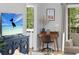 Stylish living room featuring TV, writing desk, modern furniture and view to the yard through the window at 5750 Oyster Catcher Dr. # 333, North Myrtle Beach, SC 29582