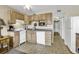 Cozy kitchen with wood cabinets, white appliances, and access to the hallway at 5905 South Kings Hwy. # 433, Myrtle Beach, SC 29575