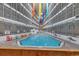 Indoor pool area with colorful decorations and tables and chairs at 5905 South Kings Hwy. # 433, Myrtle Beach, SC 29575