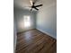 A light-filled bedroom with hardwood floors and a ceiling fan, ready for personalization at 6001 - 1766 S Kings Hwy., Myrtle Beach, SC 29575