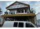 New exterior construction shows a home with a deck and construction still in progress, with a construction van parked nearby at 6001 - 1766 S Kings Hwy., Myrtle Beach, SC 29575