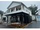 Exterior of a two-story home with white siding, black support beams, and a trailer at 6001 - 1766 S Kings Hwy., Myrtle Beach, SC 29575