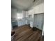 A bright kitchen featuring white cabinets, light countertops, subway tile backsplash, and wood flooring at 6001 - 1766 S Kings Hwy., Myrtle Beach, SC 29575