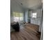 A bright kitchen featuring white cabinets, light countertops, subway tile backsplash, and wood flooring at 6001 - 1766 S Kings Hwy., Myrtle Beach, SC 29575