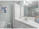 Bathroom with large mirror, white vanity, and glass shower, providing a clean and functional space at 6001 - 1807 S Kings Hwy., Myrtle Beach, SC 29575