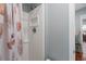 Bathroom with a shower, sea shell curtain, and an adjacent door to the house at 6001 - 1807 S Kings Hwy., Myrtle Beach, SC 29575