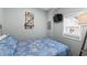 Cozy bedroom with blue floral bedding, wall decorations, and a window for natural light at 6001 - 1807 S Kings Hwy., Myrtle Beach, SC 29575