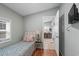 Bright bedroom with a single bed, side table, tv and view to common areas at 6001 - 1807 S Kings Hwy., Myrtle Beach, SC 29575