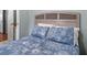 Bedroom features blue floral bedding, headboard and adjacent bathroom door at 6001 - 1807 S Kings Hwy., Myrtle Beach, SC 29575