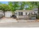 Exterior view of home with a detached garage, deck and inviting outdoor space at 6001 - 1807 S Kings Hwy., Myrtle Beach, SC 29575