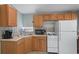 Practical kitchen with oak cabinets, tile flooring, a microwave, and a refrigerator at 6001 - 1807 S Kings Hwy., Myrtle Beach, SC 29575