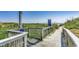 Wood-fenced beach access pathway to beach with lush greenery and ocean view at 6001 N Ocean Blvd. # 342, North Myrtle Beach, SC 29582