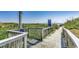 Wood-fenced beach access pathway to beach with lush greenery and ocean view at 6001 N Ocean Blvd. # 342, North Myrtle Beach, SC 29582
